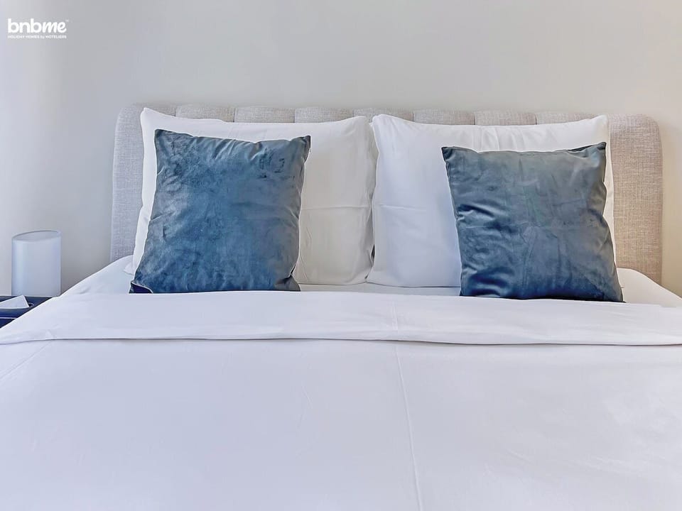 Rest easy in this elegantly designed bedroom with a queen-sized bed and an attached bathroom for added privacy.