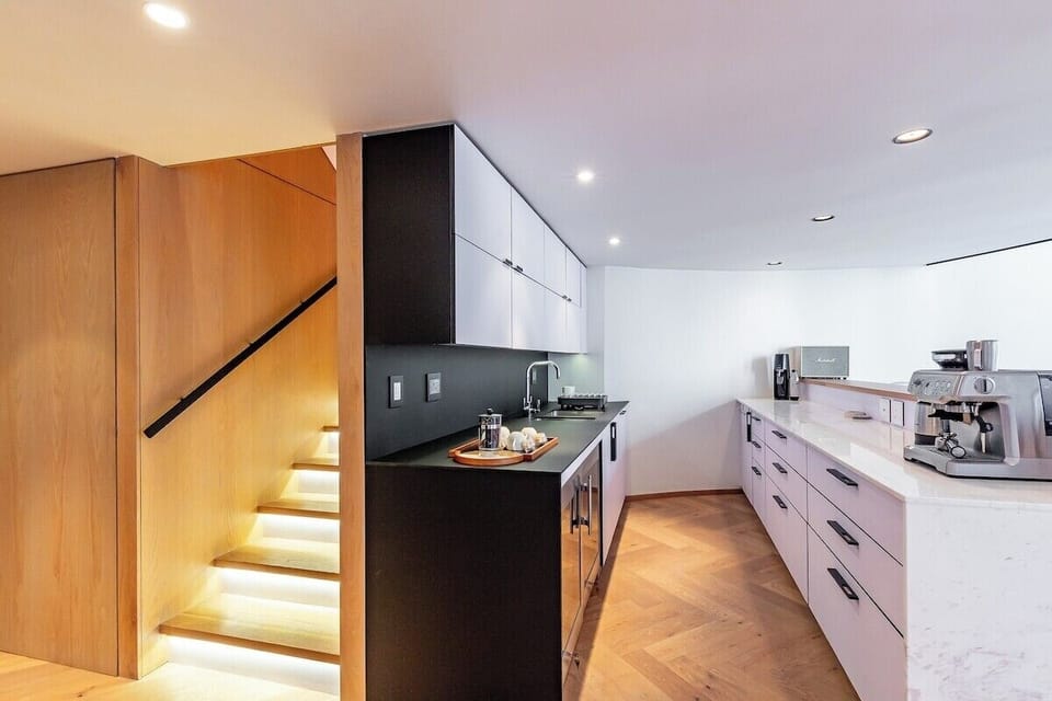 Stairs leading to the bedrooms and open plan kitchen area