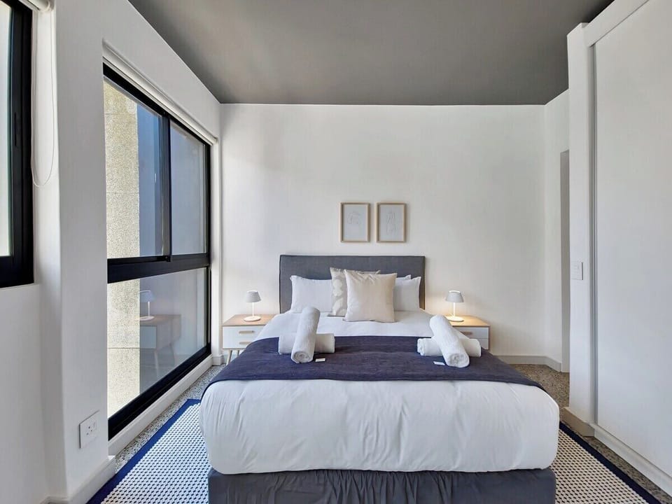 Light, airy bedroom with natural light and good quality linen
