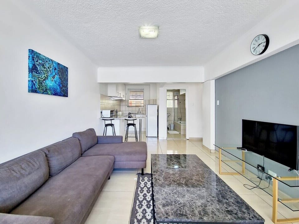 Open plan living room leading to the kitchen and dining area