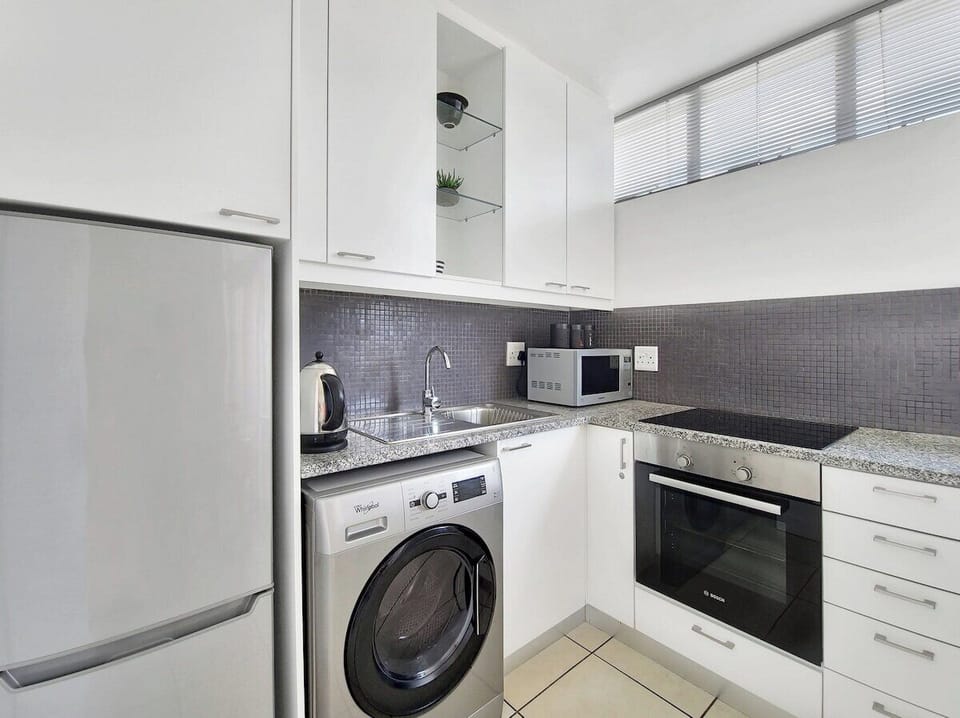 Full kitchen with modern finishes and sleek feel
