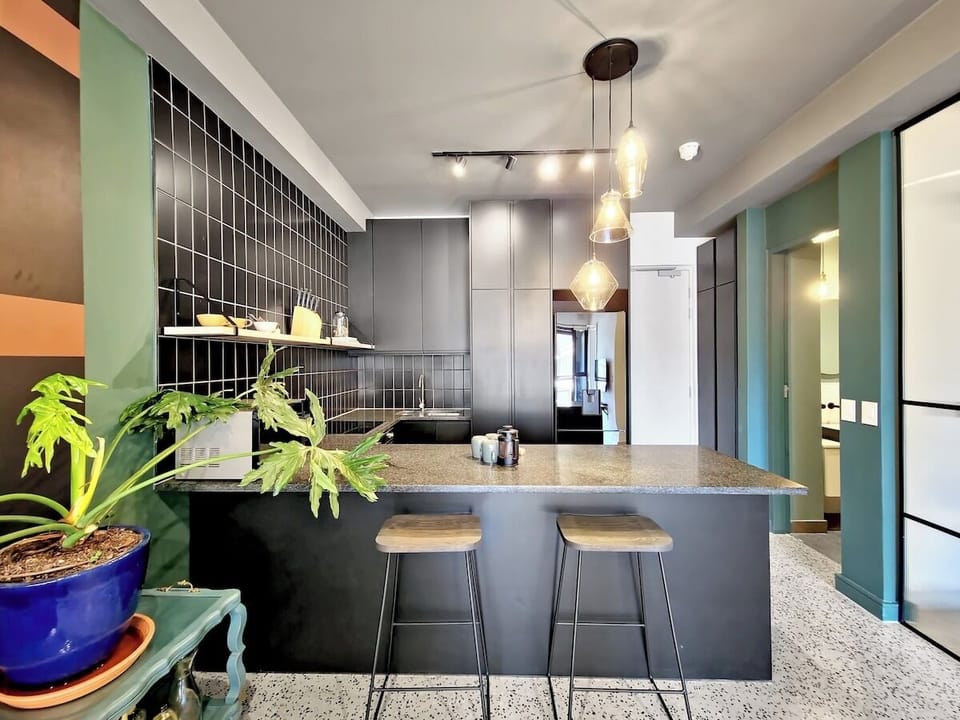 Kitchen with bar stools enabling communication to flow while rustling up a home cooked meal