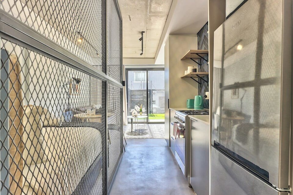 Passageway from the entrance way leading through the kitchen and to the bedroom and living area