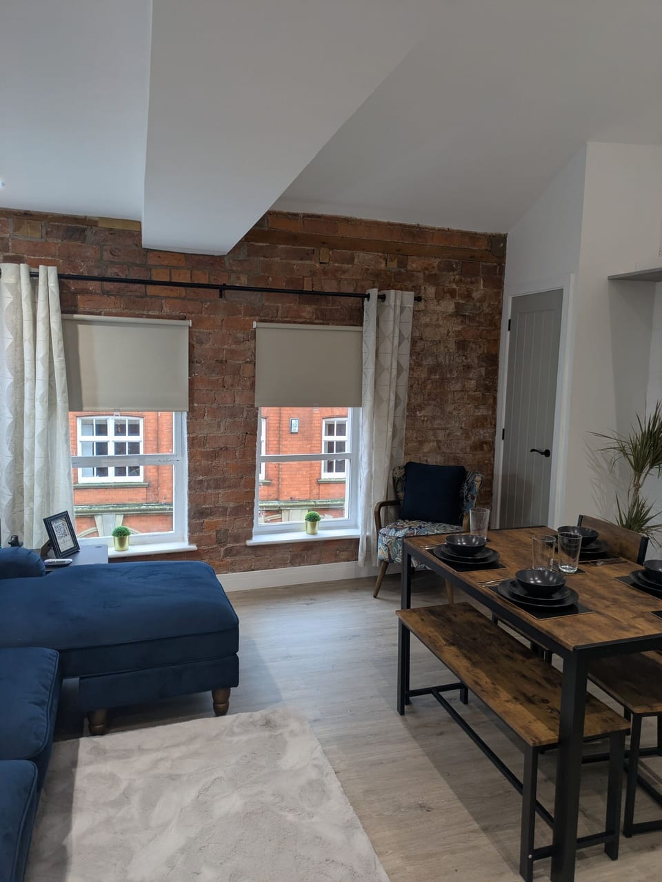 Apartment 25 – Living Room with quiet street view.  Bright open-plan living area with Smart TV, dining space and fast Wi-Fi – ideal for relaxing or remote work.