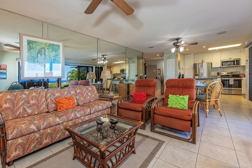 Step into your island home with open-concept living that flows seamlessly from lounge to kitchen. Colorful accents and tropical-inspired furnishings invite you to unwind in comfort while ceiling fans keep the space cool and breezy.