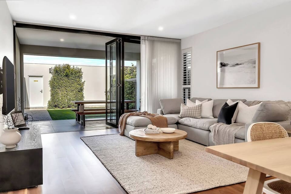 Stretch out on the large sofa and unwind with a film in the open-plan living area, then step directly onto the covered alfresco—perfect for fresh air and relaxed meals in your private backyard.