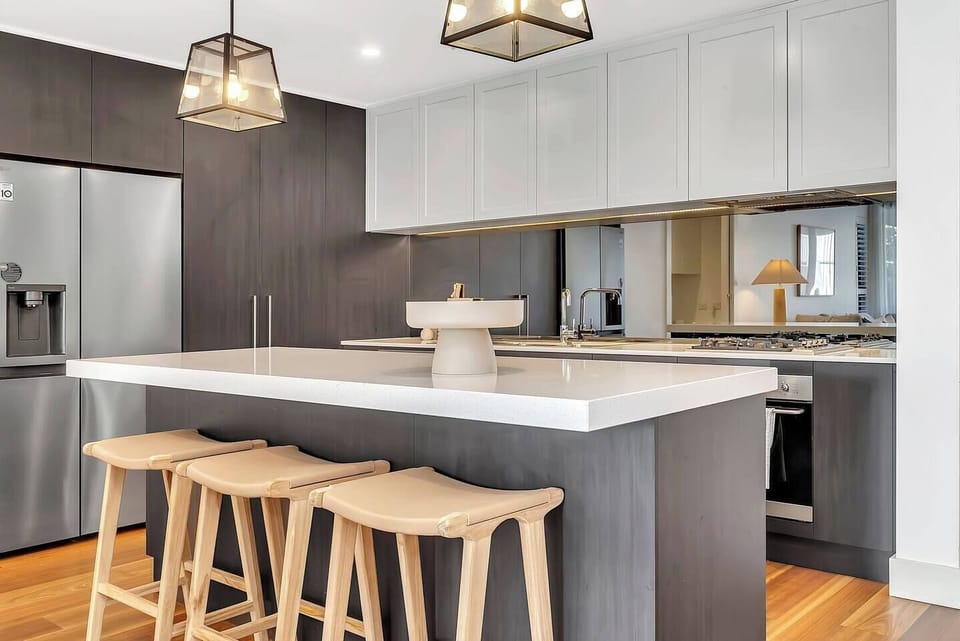 Prepare your favourite meals at the sleek island bench, equipped with bar seating and modern lighting.