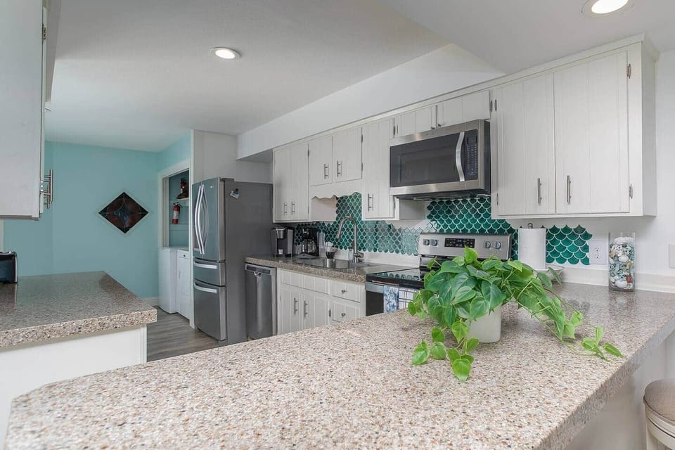 Full kitchen with plenty of counter space, laundry area towards the back.