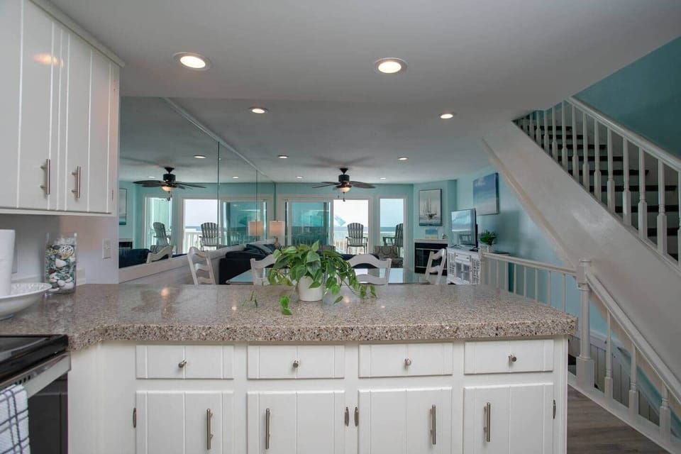 Breakfast bar with 3 bar stools on other side.