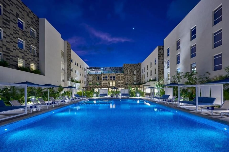 Dive into sparkling blue waters with palm-lined serenity.