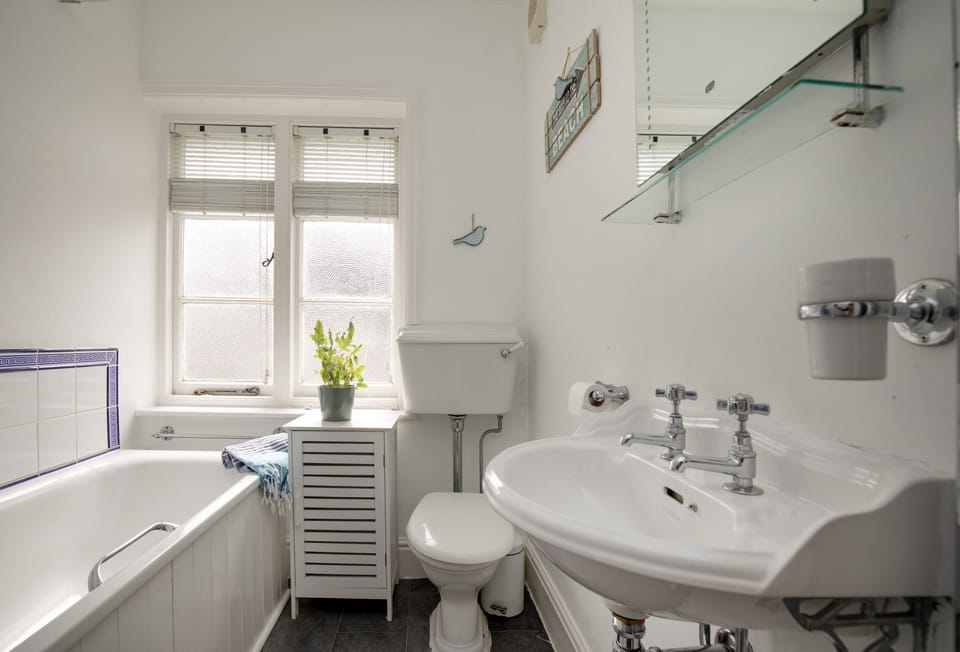 Withycombe, Beer. First floor: Family bathroom with a bath with shower over, wash basin and WC
