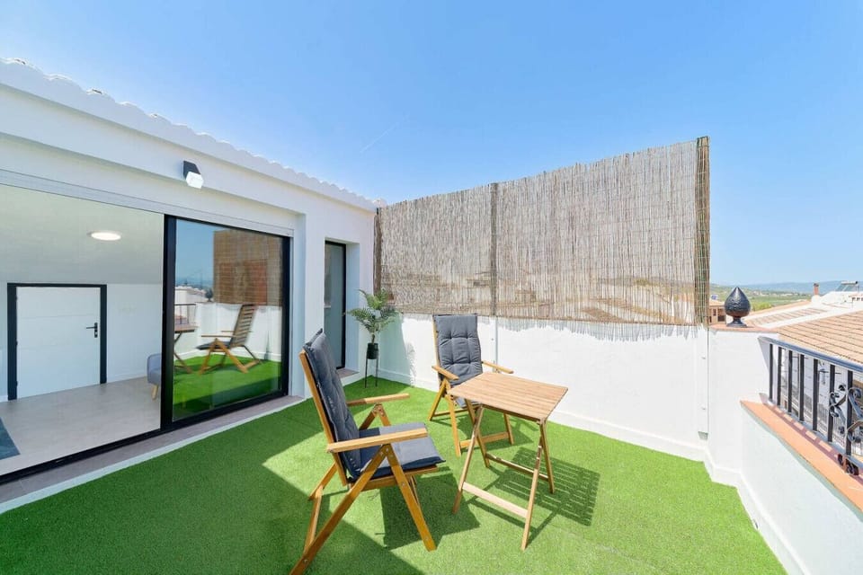Terrace wit artificial grass, and outdoor furniture.