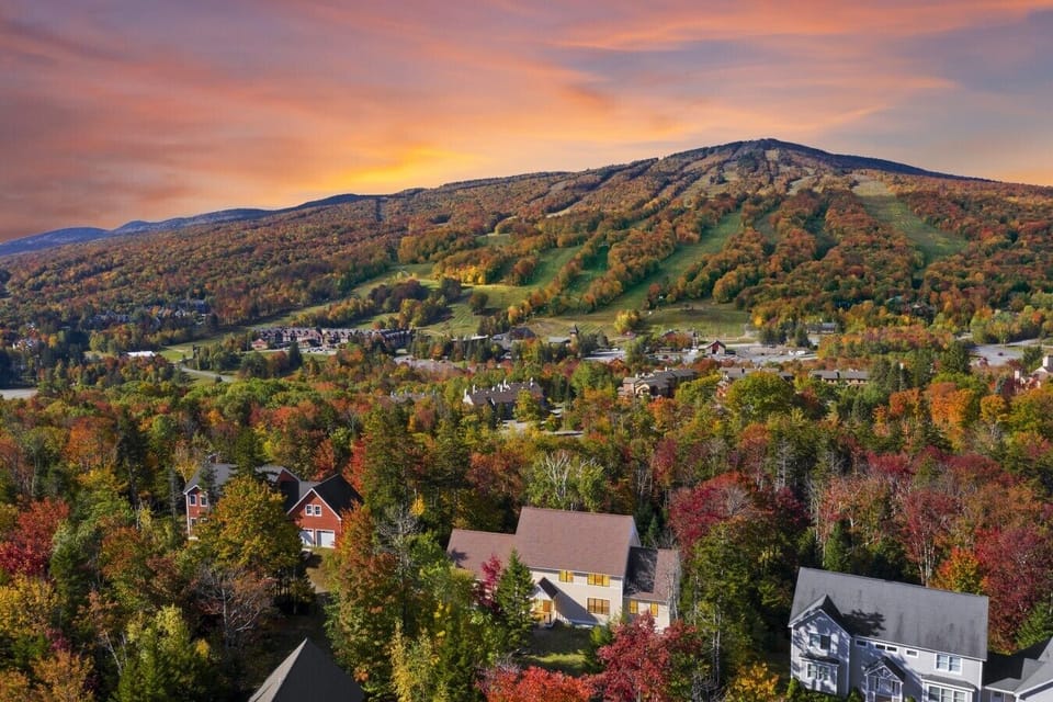 Fall in love with Vermont. Here`s an aerial view of thr home nestled among the vibrant autumn colors with Mount Snow over the horizon