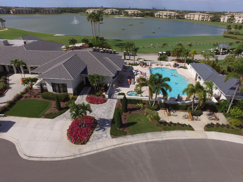 Golf Pro Shop, Main Clubhouse Pool with Aqua Range and lake behind it.