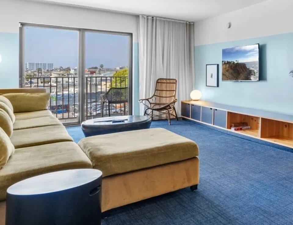 Lounge together on a deep sofa beside wide-open views.