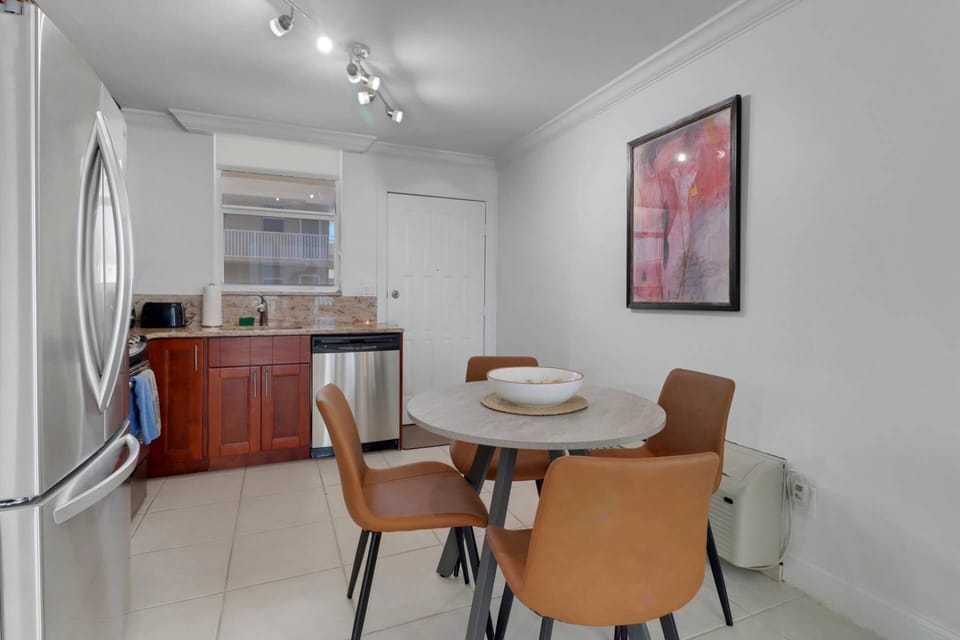 A dining table with seating for 4 is in the eat-in kitchen.