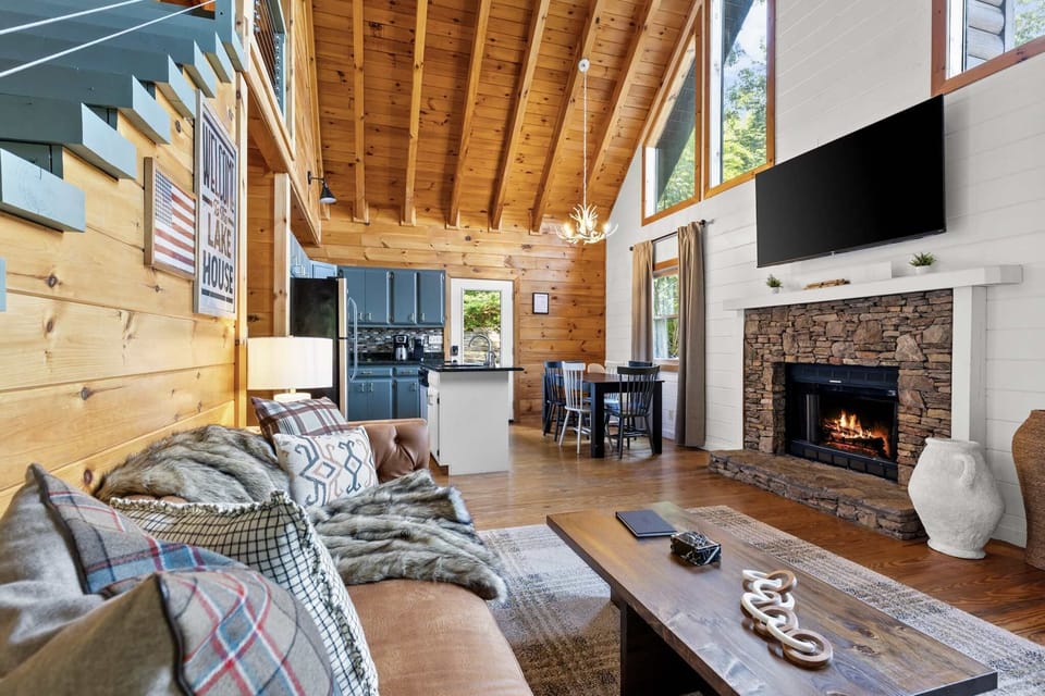 As you enter, you're welcomed by the warm embrace of our cozy living room — complete with a plush sofa, glowing fireplace, and smart TV. It’s the perfect spot to kick off your mountain retreat!


