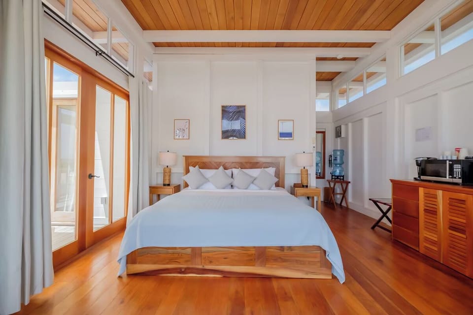 Drift off in a bright king suite with breezy views.