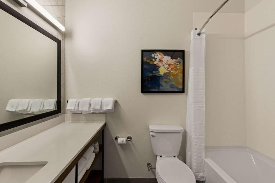 Get ready smoothly with bright vanity lighting and fresh towels.