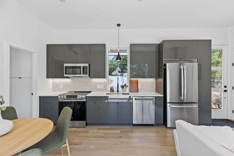 Chef-style kitchen with stainless appliances.