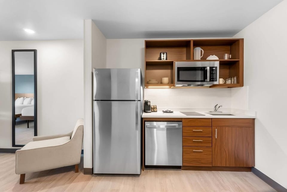 Fuel your day with a sleek kitchenette and full-size fridge.