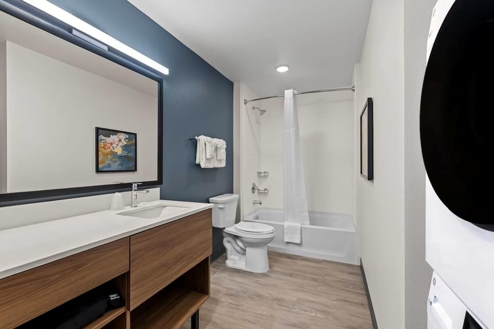 Refresh in a spotless bath with bright vanity lighting.