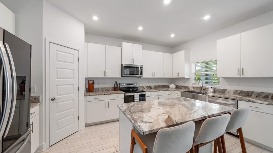 Large updated kitchen with island for meal prep and socializing.