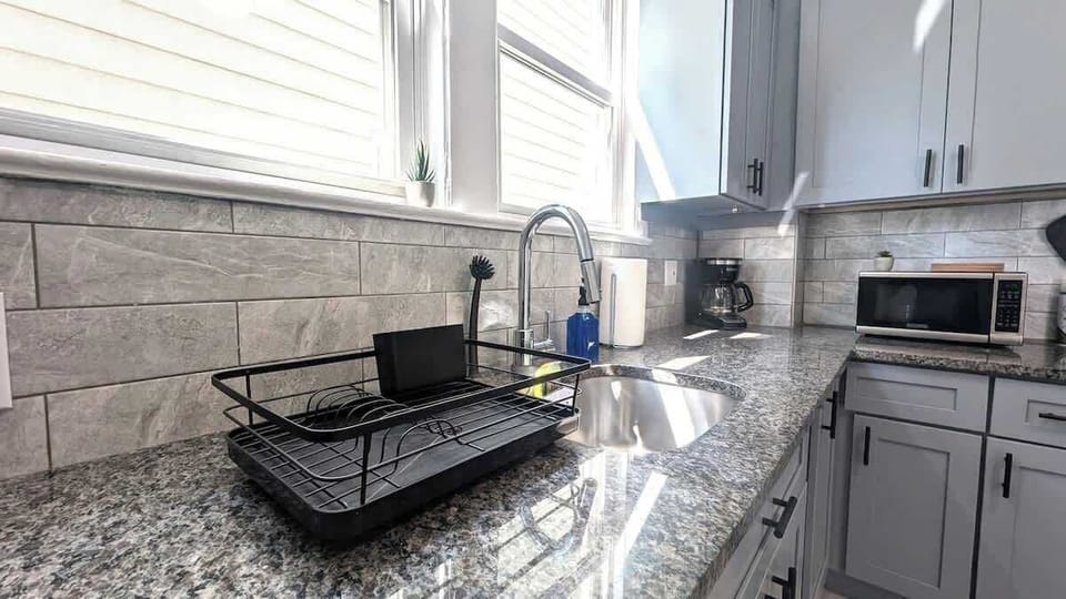 Let daylight fuel the prep. Bright windows, deep sink and spray faucet make cleanup easy after a day at American Dream Mall.