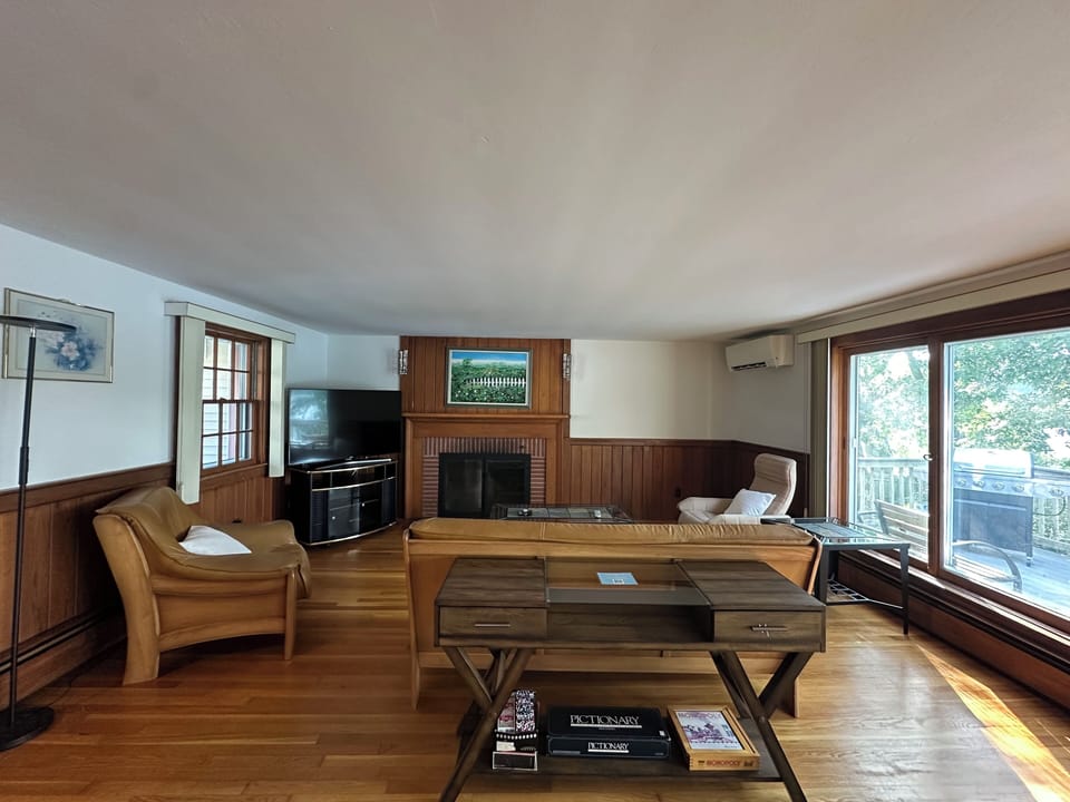 Living room with smart TV and pond views