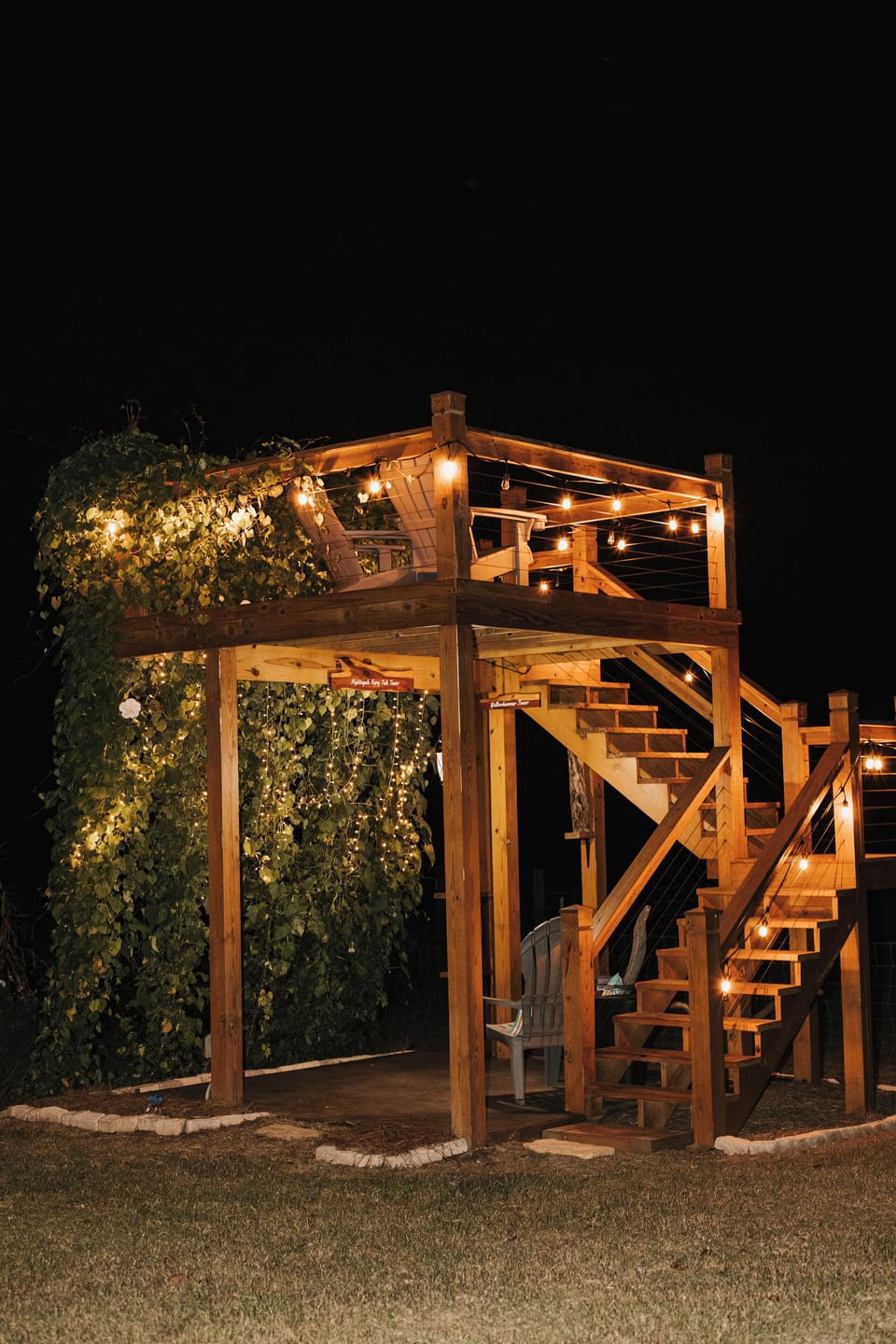 The Garden Tower on a summer night. String lights and blooming moonflowers.