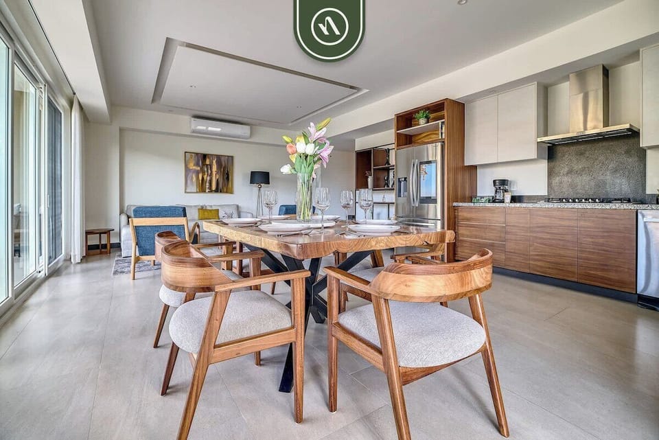 A beautiful overview highlighting the bright, open-concept layout connecting the kitchen, dining room, and comfortable lounge area.