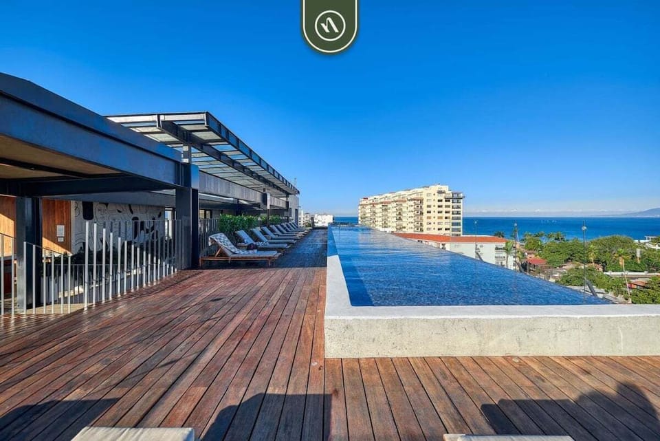 Relax on our expansive wooden deck by the incredible infinity pool. Take in the spectacular, unobstructed views of the city skyline and sparkling ocean.