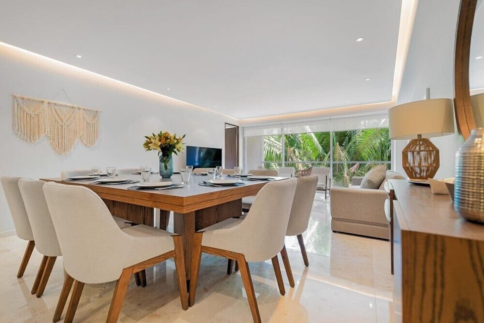 Share meals and conversation in a bright dining area with elegant furnishings and seamless indoor-outdoor flow.