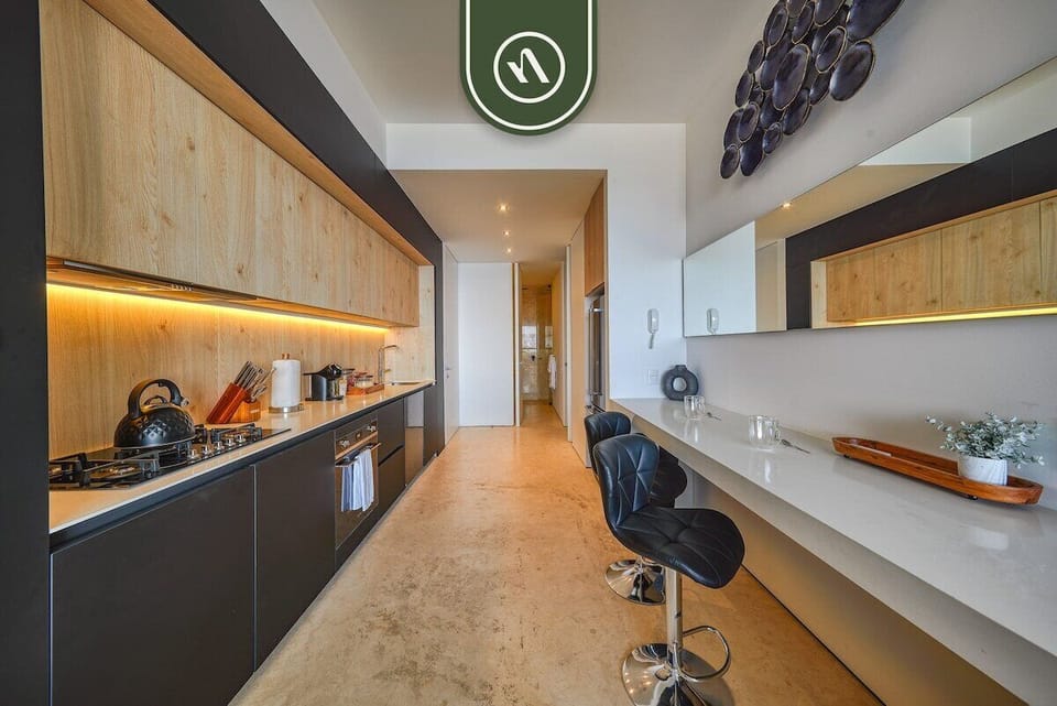 Stylish modern kitchen with high-end appliances, sleek cabinetry, and warm ambient lighting.