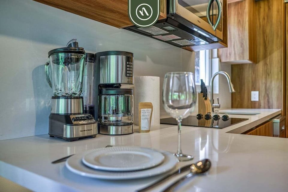 Fully equipped kitchen with custom wood cabinetry, sleek countertops, and modern appliances—perfect for cooking and gathering.