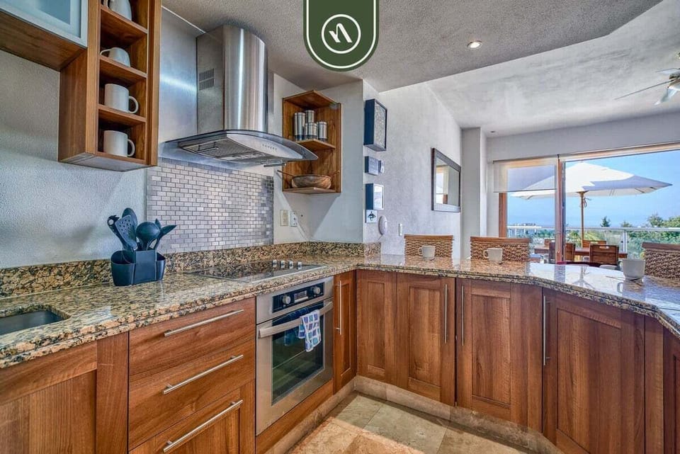 Prepare meals in style with granite countertops, premium wood cabinetry, and stainless steel appliances. The sleek backsplash and modern range make this kitchen as functional as it is beautiful.