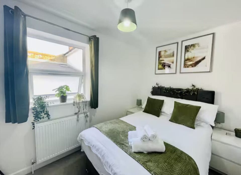 Cozy bed with fresh linens, blackout shades, and storage.
