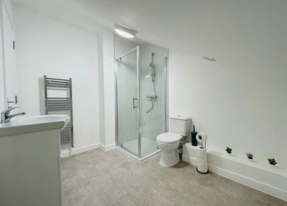 Modern bathroom with bathtub, hot water, and toiletries.