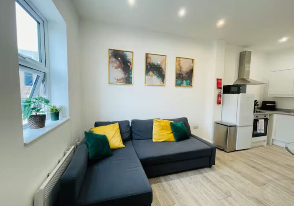 Bright and cozy lounge with comfortable seating and TV.