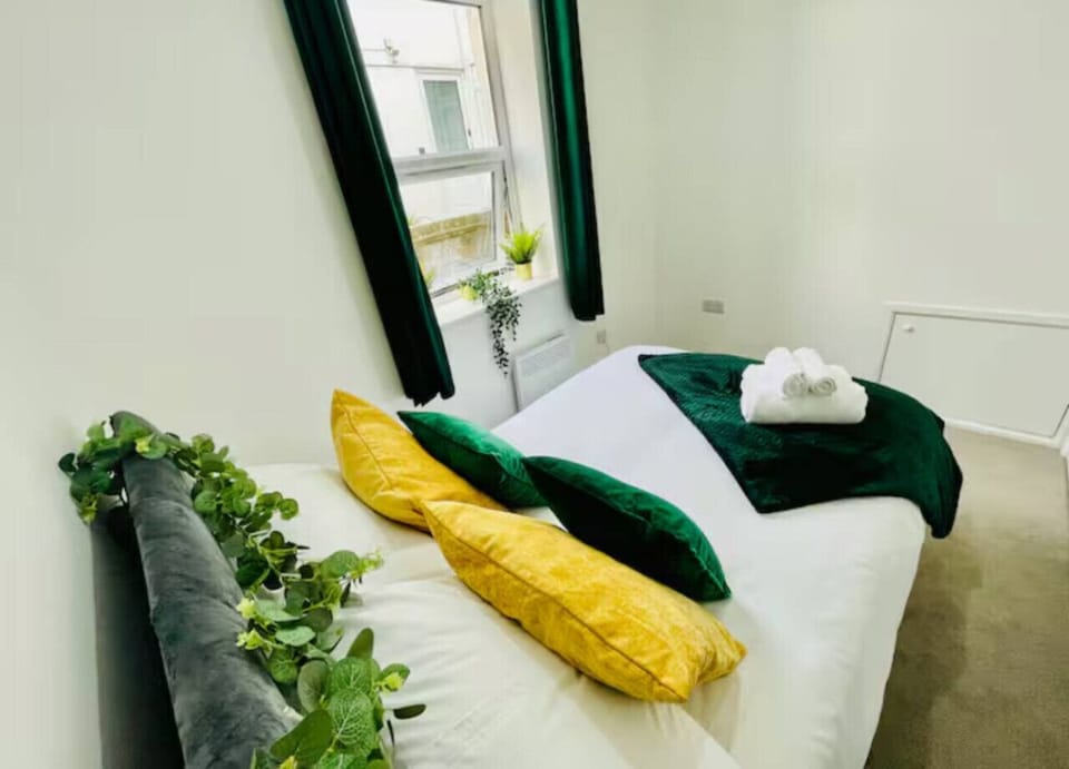Comfortable bed with fresh linens and storage.