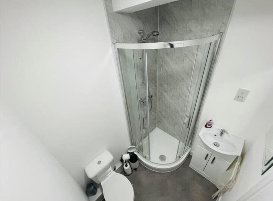 Modern setup with hot shower, bathtub, fluffy towels, hair dryer, and complimentary toiletries.
