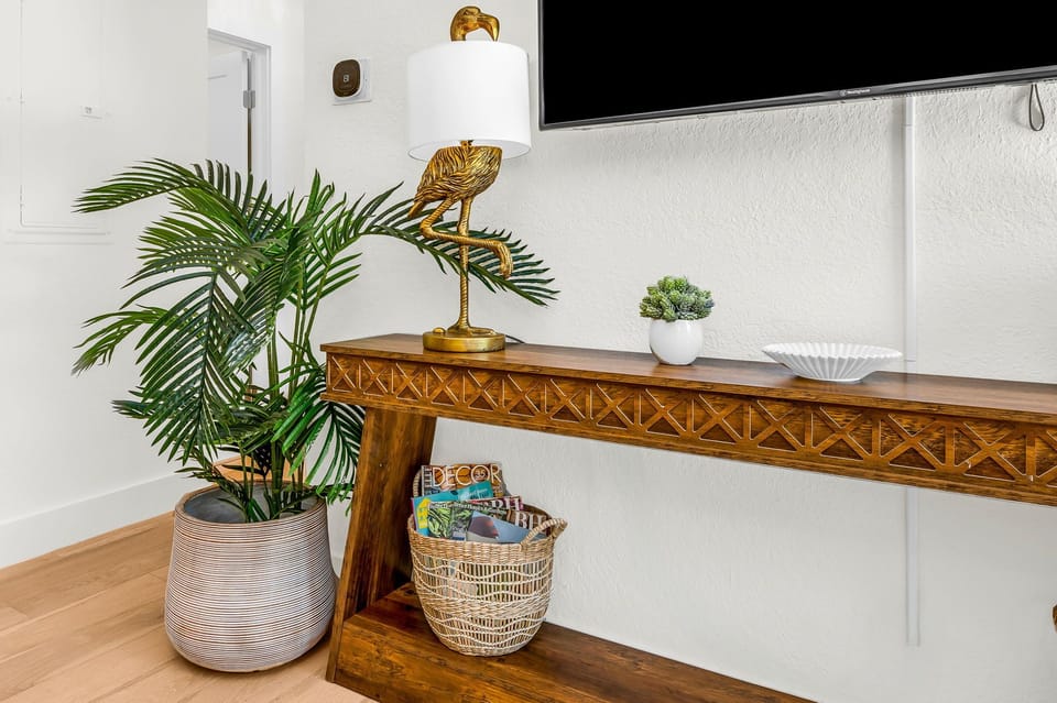 Designer touches throughout—from curated décor and tropical greenery to elegant gold accents, every element is thoughtfully styled to create a polished and inviting atmosphere.