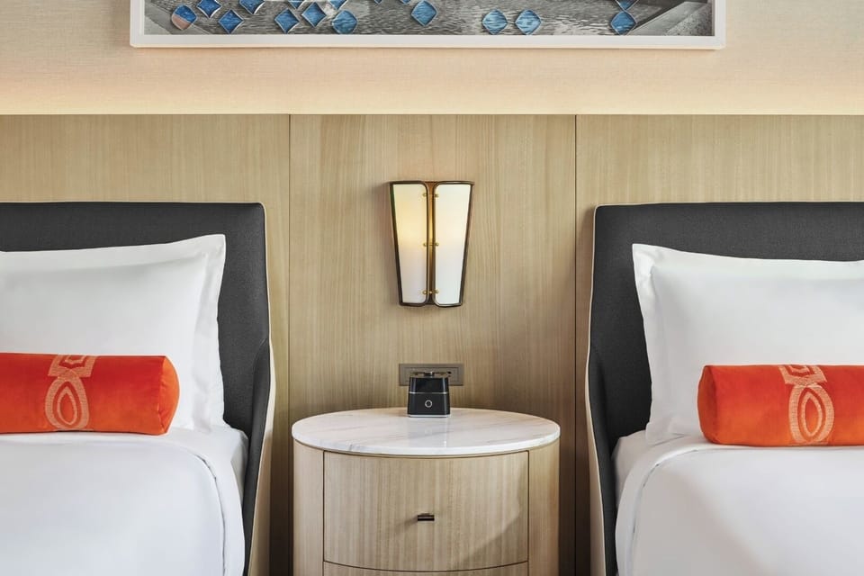Sink into crisp linens with warm bedside glow.