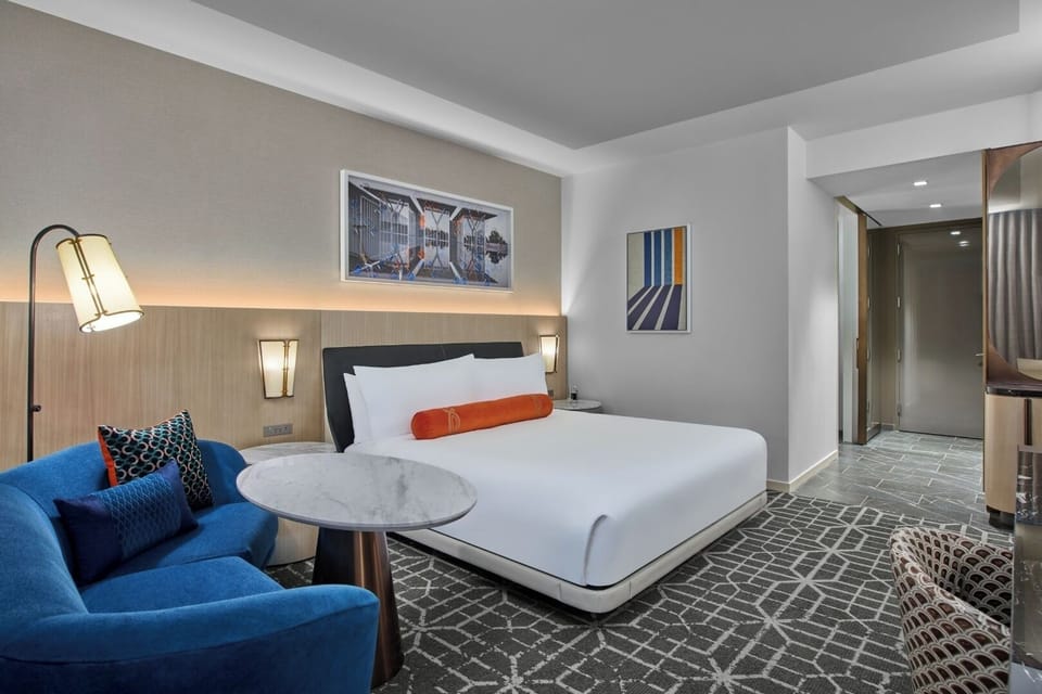 Sink into the cloud-soft bed beside a cozy sofa nook.