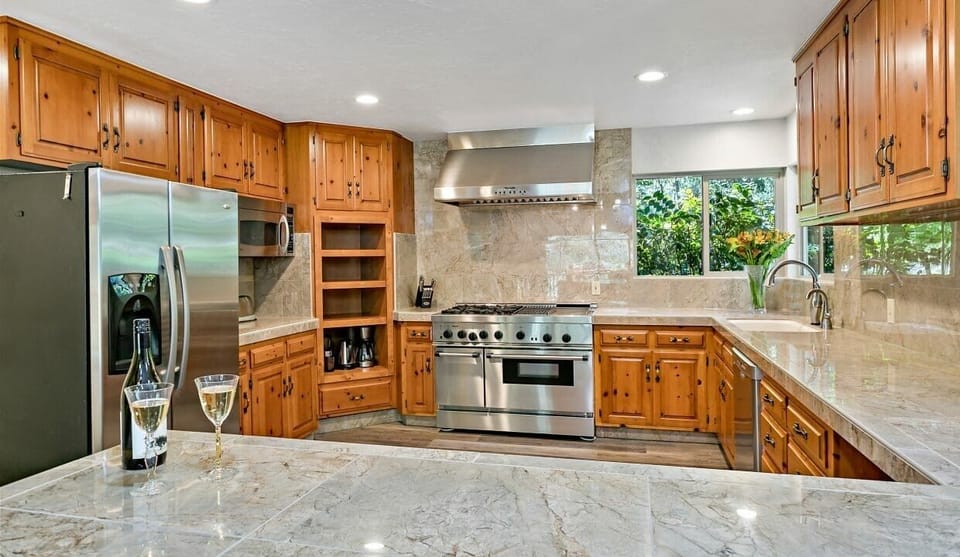 Kitchen with 2 ovens, gas range, dishwasher, microwave, 2 coffee makers, toaster