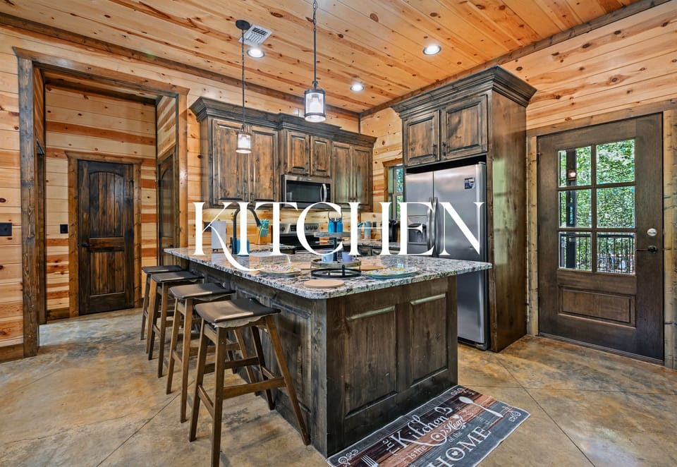 This modern-rustic kitchen has everything you need to prepare meals, with granite counters, a central island, and a spacious layout.