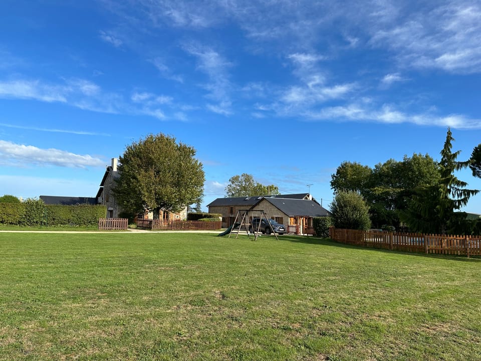 Large gardens & fields with children’s play area with slide & swing & boules court. 