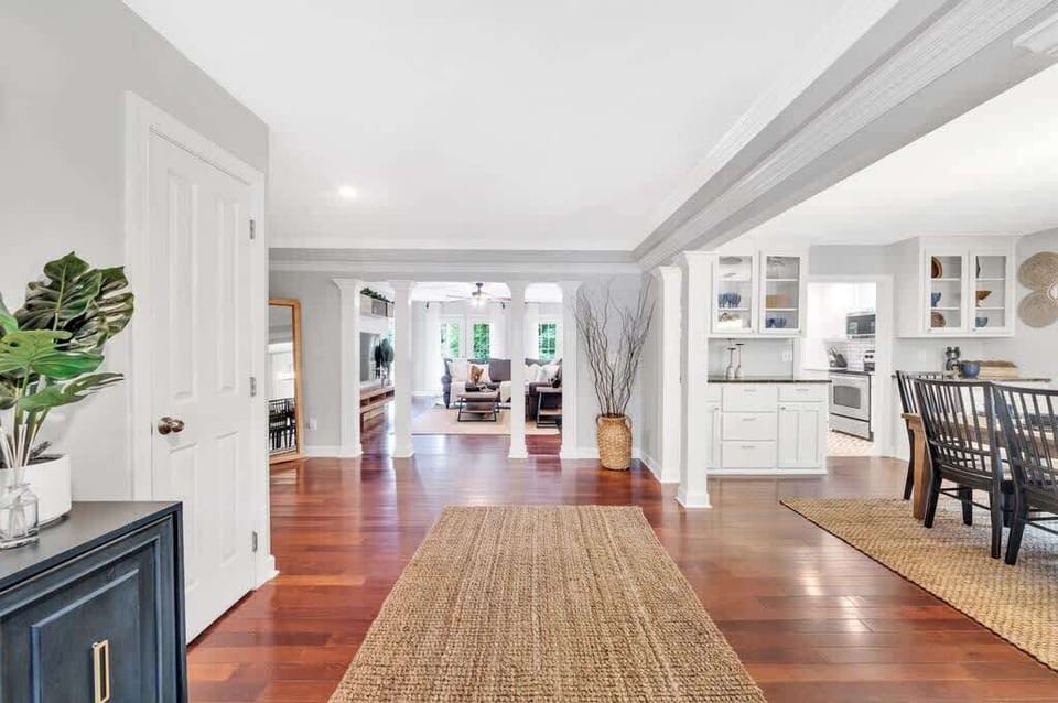 As you enter, you're greeted by an expansive open-concept layout where the kitchen, dining, and living spaces flow together seamlessly.