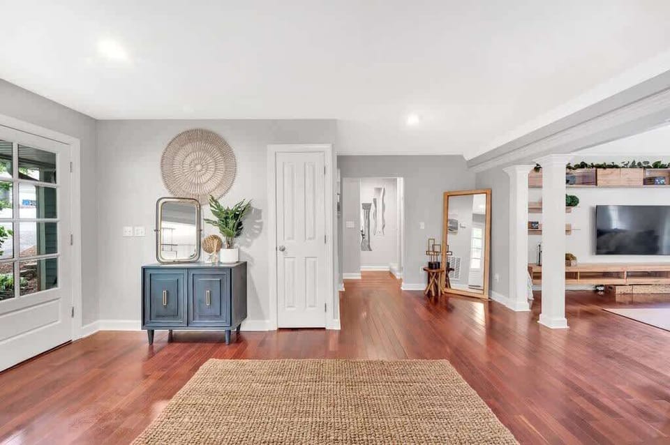 As you enter, you're greeted by an expansive open-concept layout where the kitchen, dining, and living spaces flow together seamlessly.
