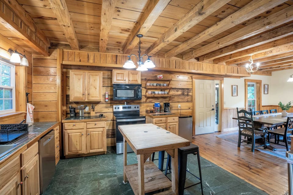 A long farmhouse table set for shared meals and late-night card games alike.